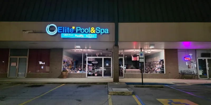 Elite Pool & Spa storefront at night